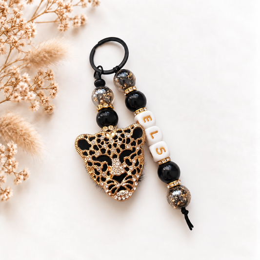Luxe sleutel- en tassenhanger Black Leopard met naam in zwart en goud en luipaarddetail